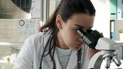 Female Researcher Using Microscope in Laboratory Stock Footage