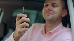 Male hand holding car keys of new vehicle Stock Footage