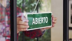 SLOW-MO: Young man opening a Spanish shop Stock Footage