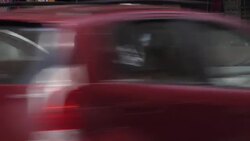 Streetscene and traffic moving down street News Clip