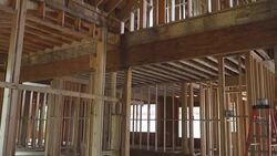 Framing structure wood frame of wooden houses home. Closeup new stick built home under construction under blue sky. real estate concept background. Stock Footage