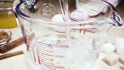 Slow motion glass measuring cup on the table near the ingredients Stock Footage