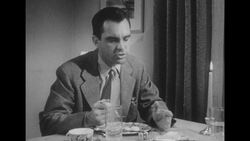 1950s: Wife sits at dinner table Stock Footage