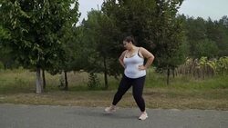 Fat girl runs along the road Stock Footage