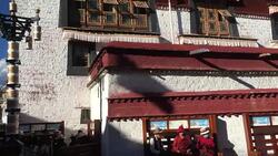 Pilgrims rest under the wall of Jokhang temple at sunset. Stock Footage