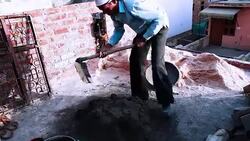 Worker mixing cement on construction site. Stock Footage
