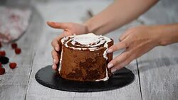 Making trendy rustic vertical roll high cake with chocolate, vanilla cream and raspberries. Stock Footage