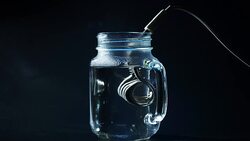 Boiling water with immersion heater Stock Footage