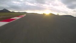 POV: Cinematic view of driving a fast car down an empty raceway at sunrise. Stock Footage