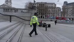 Police Officer Walking Across Trafalgar Square News Clip