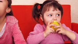 Children eat an apple. Stock Footage