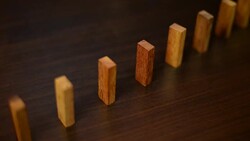 Stopping domino risk effect by hand Stock Footage