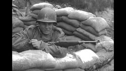 GI soldier keeps snow off sandbags at the Korean War front line News Clip