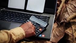 Close up of human hand working with laptop & calculator Stock Footage