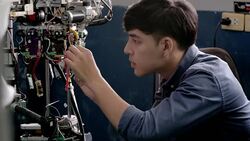 Teenage works on a fully functional programable Robot for robotics club project.Creative designer testing robotics prototype in workshop.Science concept Stock Footage