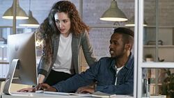 African Man Discussing Project with Female Coworker Stock Footage