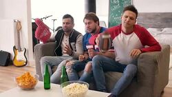 Disappointed football fans watching match in disbelief Stock Footage