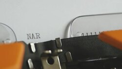Close up footage of a person writing NARCOTICS on an old typewriter Stock Footage