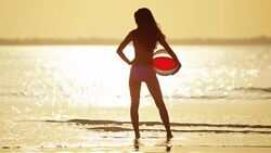 Multi ethnic girlfriends in swimwear on ocean beach Stock Footage