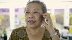 Asian Senior woman talking on phone in supermarket Stock Footage