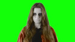 Checking the treats - teenage girl, disguised for Halloween, standing in an eerie, foggy environment Stock Footage