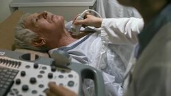 Doctor Doing Ultrasound Exam of Senior Patient Stock Footage