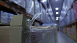Boxes on packed shelving at Warehouse cold storage News Clip
