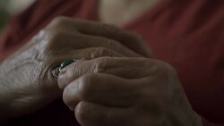 Old woman touching ring on finger feeling sad Stock Footage