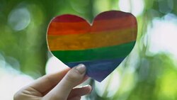 Female hand holding rainbow paper heart, recognition of sexual minorities rights Stock Footage