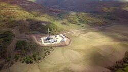 Aerial View of a Fracking Drilling Rig in the Autumn Mountains of Colorado Stock Footage