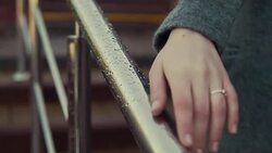 Close up of woman hands on metalic railing with water drops Stock Footage