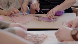 Woman enjoying art and craft project, assembling string art in office Stock Footage