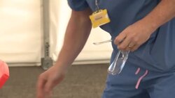 NHS nurse conducting coronavirus swab tests News Clip