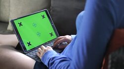 Woman using Digital Tablet with Green Screen in Landscape Mode at Work Stock Footage