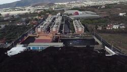 Lava from Spain's La Cumbre Vieja volcano surrounds houses News Clip