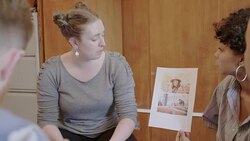 Creative designers discussing photograph proofs in meeting Stock Footage