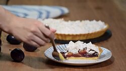 Delicious sliced cake of ripe plums close-up on the table. Stock Footage