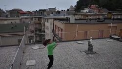 CLEAN : Italian tennis youngsters practice from the roof during virus lockdown News Clip