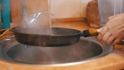 Woman Washes a Hot Frying Pan Under Running Water in a Domestic Kitchen. Slow Motion Stock Footage