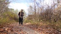 Men walking with automatic rifles to gun range News Clip