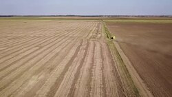 Aerial view of agricultural tractor on dirt road Stock Footage