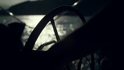 Woman steers the yacht with leg Stock Footage