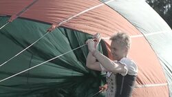 German woman prepares air balloon for flight Stock Footage