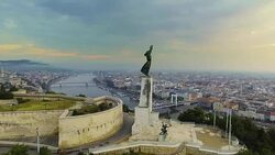 Flying around of Statue of Liberty with the skyline of Budapest at background. Budapest, Hungary - 4K aerial footage at sunrise Stock Footage