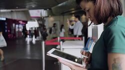 Designer drawing a sketch on tablet using stylus at city Stock Footage