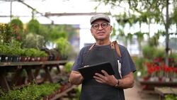 Portrait of Garden Market Employee / Owner Using Digital Tablet Stock Footage