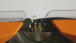 Close up footage of a person writing AUTISMUS on an old typewriter, with sound Stock Footage