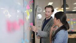 Coworkers brainstorming in an office Stock Footage