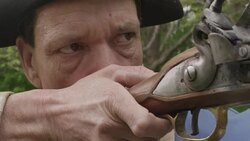 Revolutionary War soldier placing finger on trigger of musket Stock Footage