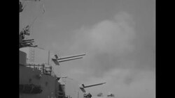 Battleship fires upon mountains along coast during Korean War News Clip